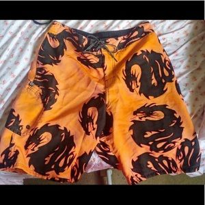 Orange shorts/swimming trunks with black dragons